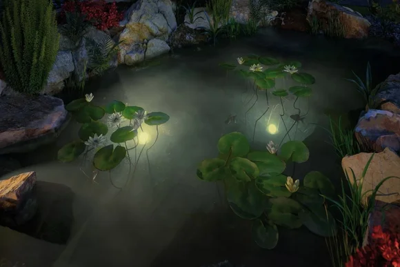 Beleuchteter Gartenteich mit Seerosen